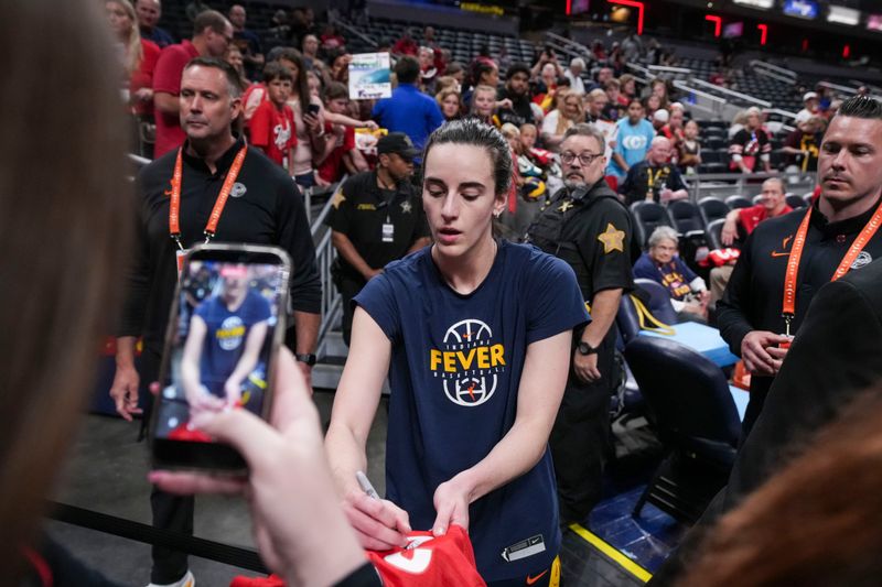 Indiana Fever guard Caitlin Clark (22) signs an autograph Thursday, June 4, 2026, before a game at Gainbridge Fieldhouse in Indianapolis.