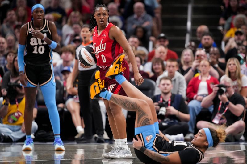 Indiana Fever guard Kelsey Mitchell (0) reacts to a call Thursday, June 4, 2026, during the first half of a game at Gainbridge Fieldhouse in Indianapolis.