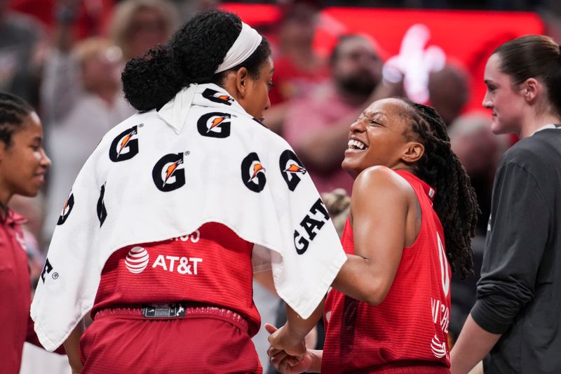 Indiana Fever guard Kelsey Mitchell (0) smiles while talking with Indiana Fever forward Monique Billings (25) on Thursday, June 4, 2026, during the second half of a game at Gainbridge Fieldhouse in Indianapolis. The Indiana Fever defeated the Atlanta Dream, 83-71.