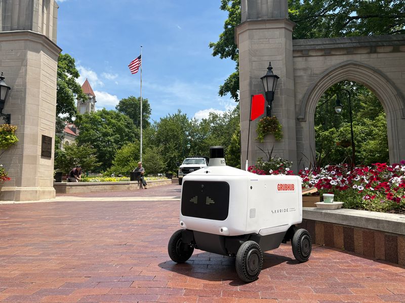 A robot with a food delivery waits for a customer to pick up their order at the Indiana University Sample Gates on Thursday, June 4, 2026, during a practice run.