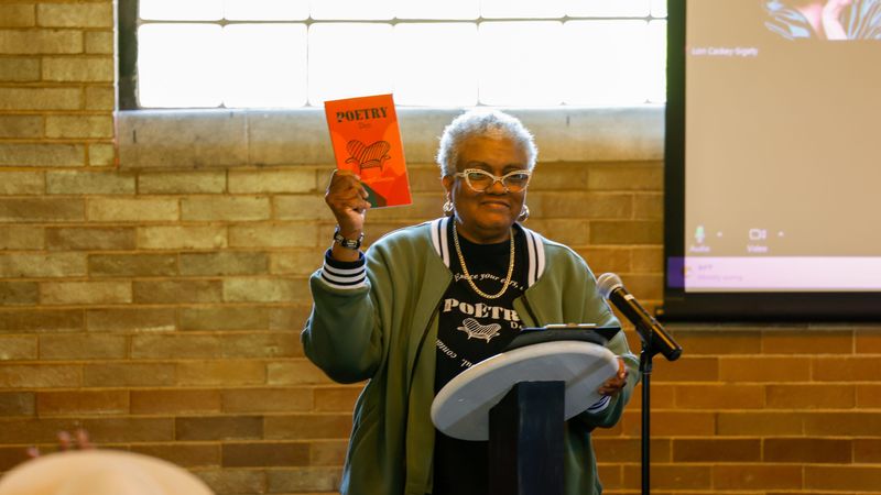 Pam Blair holds a copy of the book “The Poetry Den: Literary Collective,” which features the work of 20 poets who regularly read at The Poetry Den in South Bend. Blair founded The Poetry Den, which takes place the fourth Sunday of each month at the Civil Rights Heritage Center in South Bend.