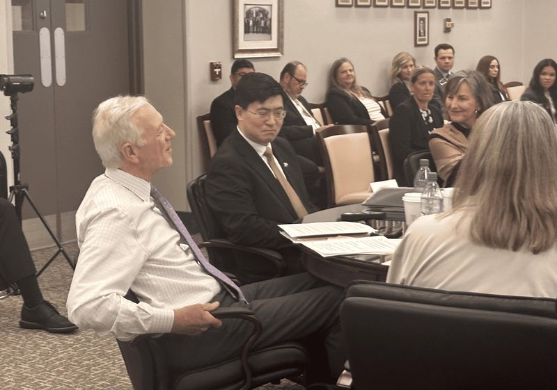 Purdue President Mung Chiang closely listens to trustees Chairman Gary Lehman's speech outlining the legacy of his presidency.