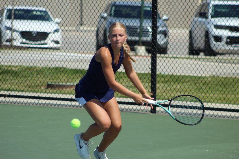 Delta senior Stella Sieber takes a swing in her No. 3 singles match during the Eagles' quarterfinal match against Munster at the IHSAA girls tennis state finals at North Central High School on Friday, June 5, 2026.