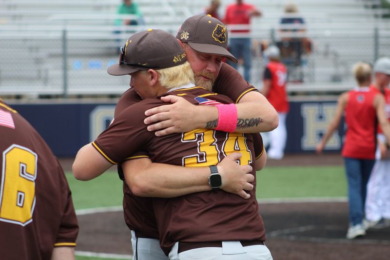 Monroe Central baseball coach Sean Richardson shares an embrace with sophomore Caleb Luedike following the Golden Bears' loss to North Miami in an IHSAA Class 1A regional championship at Oak Hill on Saturday, June 6, 2026.