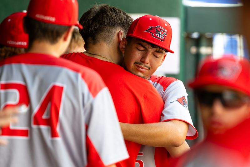 Goshen’s starting pitcher Ryen Diaz (15) hugs teammates after being relieved during the Goshen vs. Lake Central regional championship baseball game Saturday, June 6, 2026 at Four Winds Field.