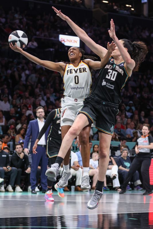 Jun 6, 2026; Brooklyn, New York, USA; Indiana Fever guard Kelsey Mitchell (0) drives past New York Liberty forward Breanna Stewart (30) in the second quarter at Barclays Center. Mandatory Credit: Wendell Cruz-Imagn Images