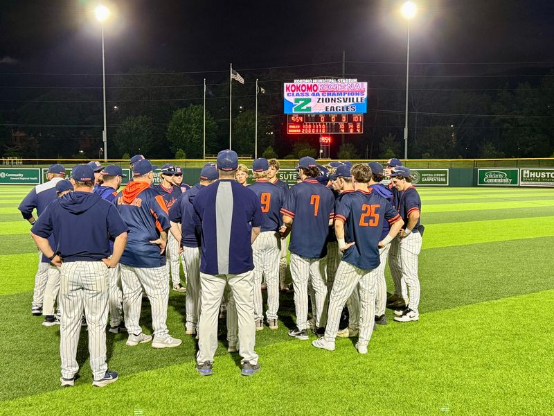 Harrison baseball players congregate in the outfield at Kokomo Municipal Stadium on June 6, 2026 following a regional loss to Zionsville.