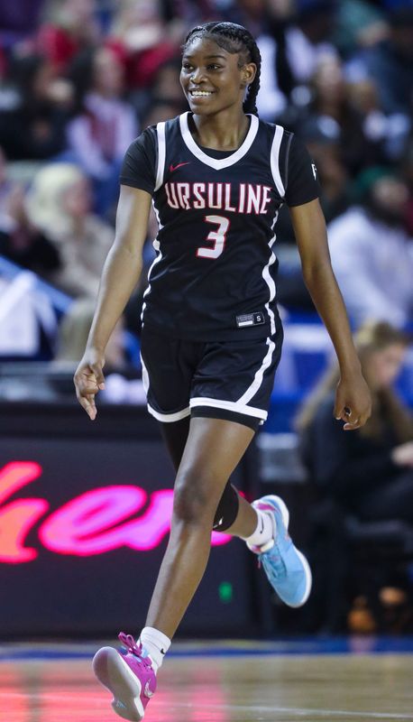 Ursuline's Jezelle "GG" Banks reacts to a three-pointer in the second half of the Raiders' 49-48 win against Caravel in the DIAA championship at the Bob Carpenter Center, Saturday, March 9, 2024.