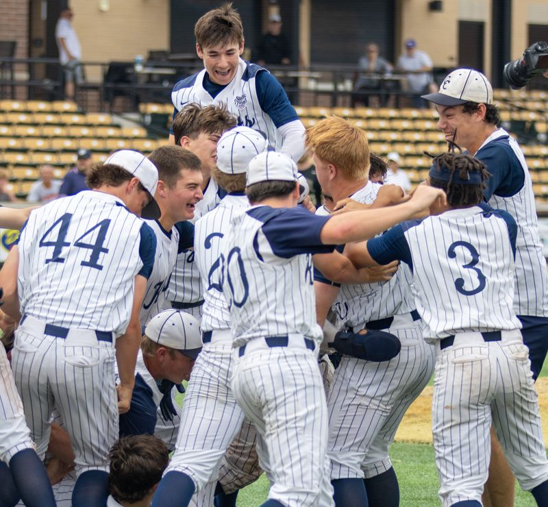 Central Catholic players embrace following the game winning hit by Gus Sandberg on Monday, June 8, 2026, following the regional championship game at Loeb Stadium in Lafayette, Indiana. Lafayette Central Catholic defeated Lapel, 3-2.