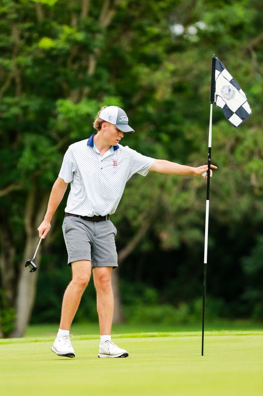 Harrison's Isaac Wendt tends the flag in the IHSAA boys golf sectional at the Battleground Golf Club on June 8, 2026.