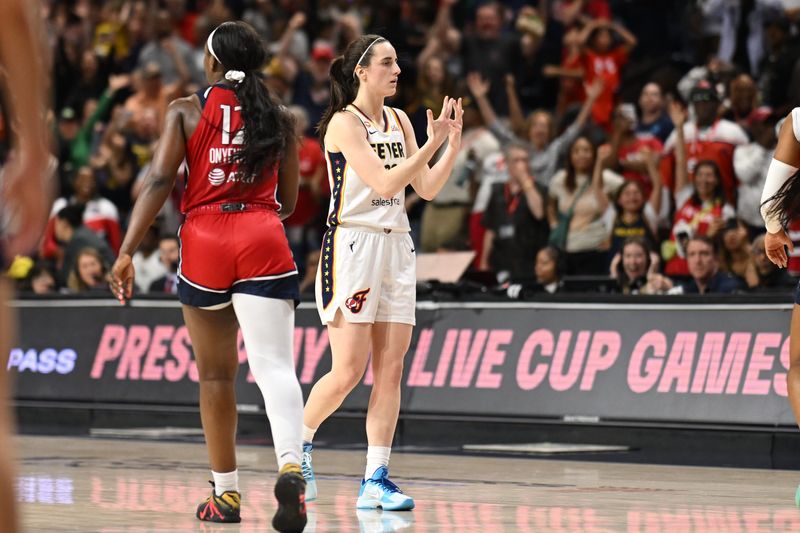 Jun 8, 2026; Washington, District of Columbia, USA; Indiana Fever guard Caitlin Clark (22) reacts after making a game winning three-point basket against the Washington Mystics during the fourth quarter at CareFirst Arena.