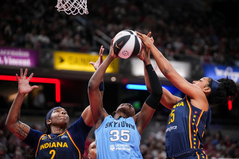 Indiana Fever forward Myisha Hines-Allen (2), Chicago Sky guard Aicha Coulibaly (35) and Indiana Fever forward Monique Billings (25) go for the ball Thursday, June 11, 2026, during the first half of a game at Gainbridge Fieldhouse in Indianapolis.