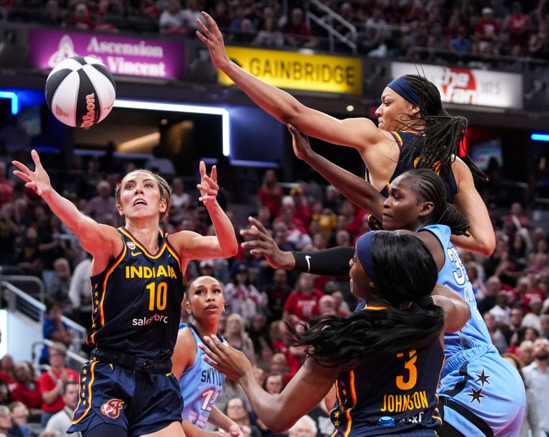 Indiana Fever guard Lexie Hull (10), Indiana Fever forward Makayla Timpson (21), Chicago Sky guard Aicha Coulibaly (35) and Indiana Fever guard Raven Johnson (3) go for the ball Thursday, June 11, 2026, during the second half of a game at Gainbridge Fieldhouse in Indianapolis. The Indiana Fever defeated the Chicago Sky, 114-106.