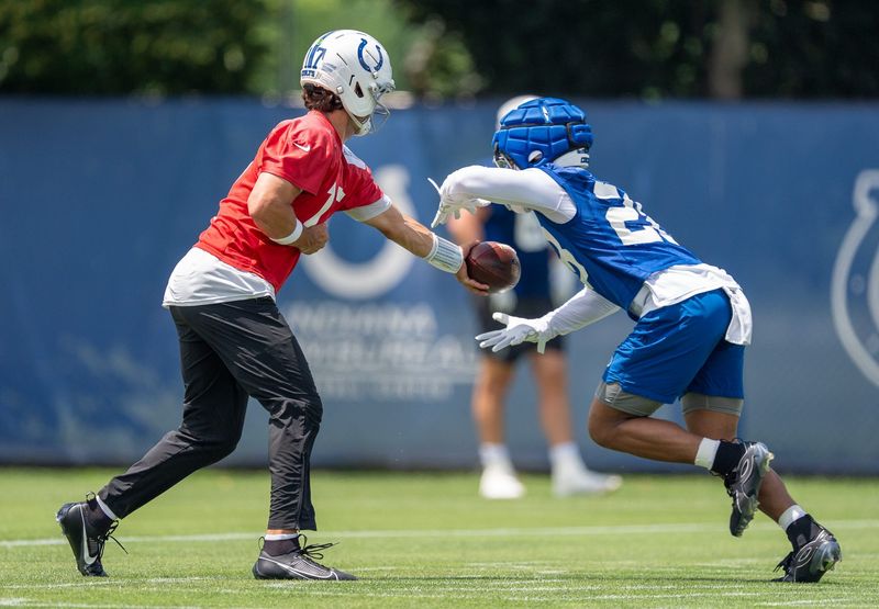 Indianapolis Colts quarterback Daniel Jones (17) hands the ball off Wednesday, June 10, 2026, to running back Jonathan Taylor (28) during minicamp at Indiana Farm Bureau Football Center in Indianapolis.