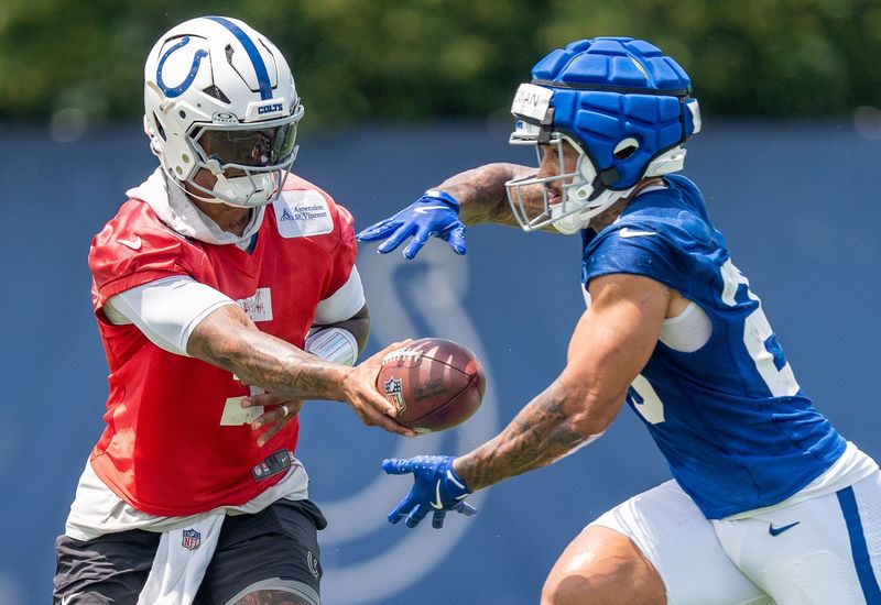 Indianapolis Colts quarterback Anthony Richardson Sr. (5) hands the ball off Wednesday, June 10, 2026, to running back Seth McGowan (20) during minicamp at Indiana Farm Bureau Football Center in Indianapolis.