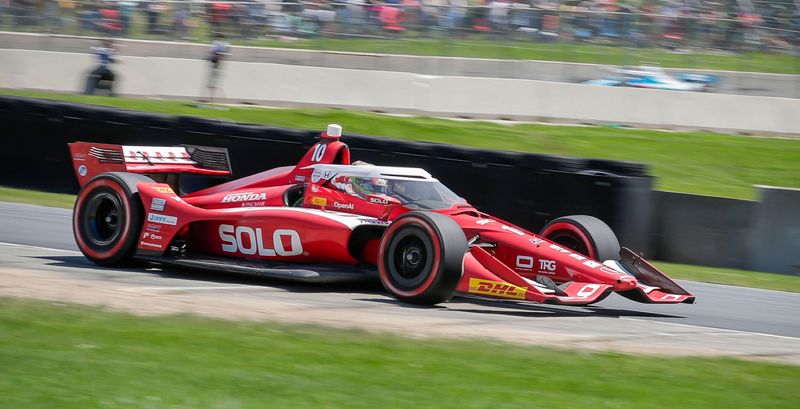 Alex Palou (10) is a blur out of turn 5, Sunday, June 22, 2025, at the IndyCar XPEL Grand Prix at Elkhart Lake's Road America near Elkhart Lake, Wis.
