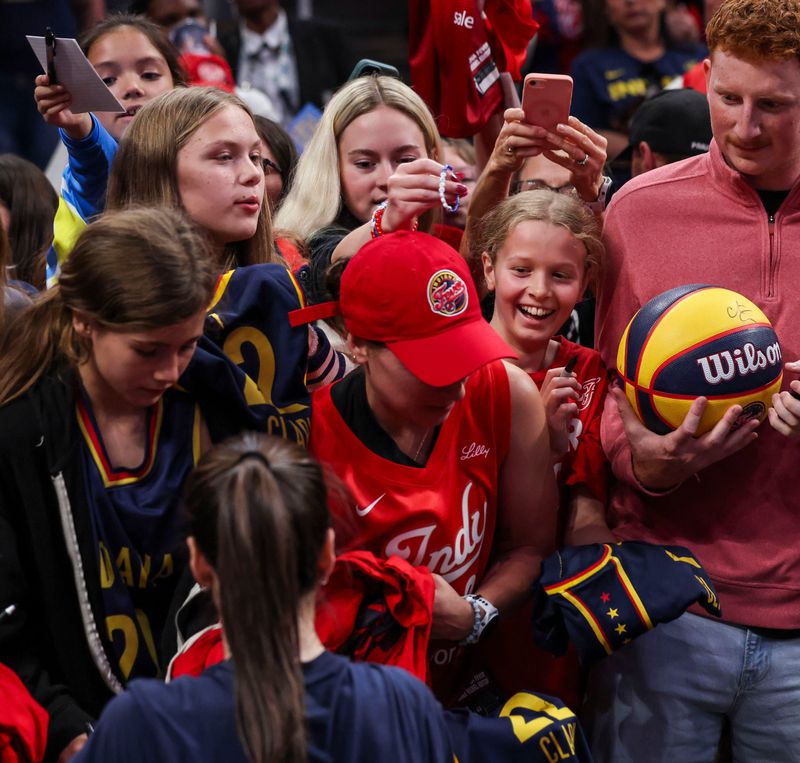 Indiana Fever guard Caitlin Clark (22) signs autographs Thursday, June 18, 2026, before a game at Gainbridge Fieldhouse in Indianapolis.