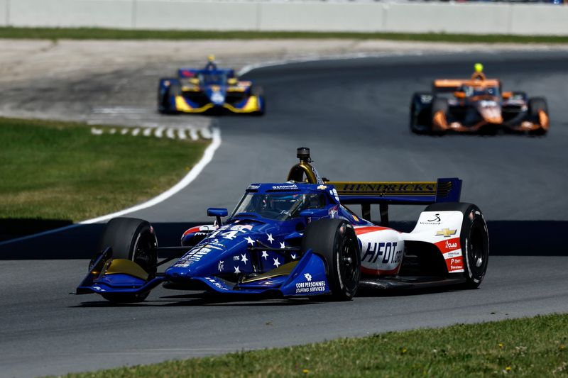 Santino Ferrucci leads a pack of cars into theh Carousel on qualifying day at the NTT IndyCar Series XPEL Grand Prix, Saturday, June 20, 2026, at Road America in Elkhart Lake, Wisconsin.