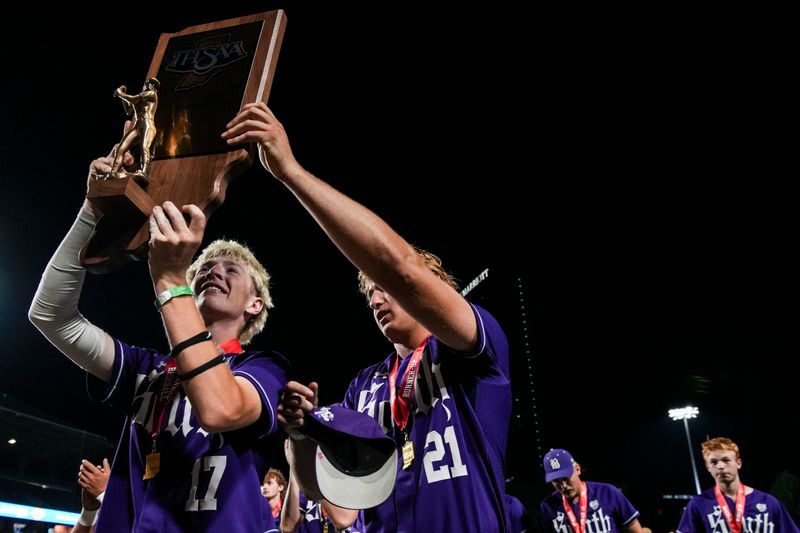 Bloomington South Panthers catcher Jake McCammon (17) and Bloomington South Panthers first baseman Luke Arnett (21) hoist the second place trophy Saturday, June 20, 2026, after the IHSAA Class 4A baseball state championship at Victory Field in Indianapolis. Lake Central defeated the Bloomington South Panthers, 4-0.