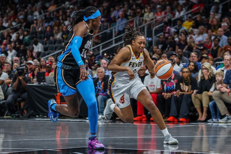 Jun 20, 2026; Atlanta, Georgia, USA; Indiana Fever guard Kelsey Mitchell (0) dribbles the ball towards the basket against Atlanta Dream guard Rhyne Howard (10) during the first quarter at State Farm Arena.