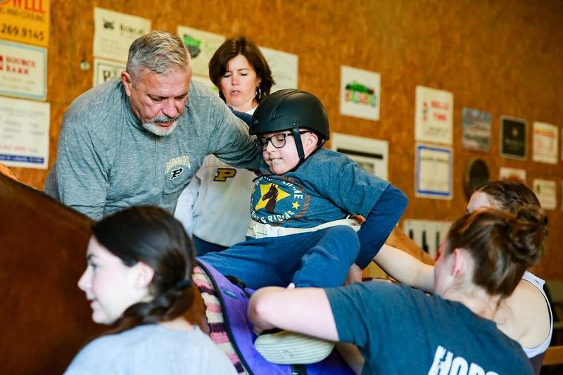 Kevin Van Gorder helps his son, Eli, sit on Dreamer.