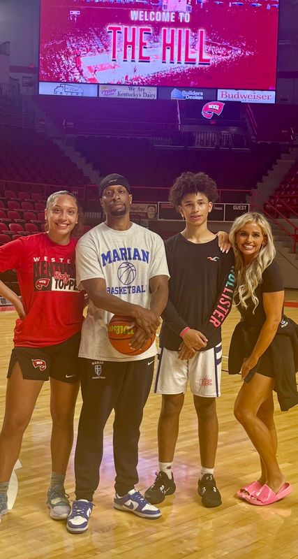 Nevaeh (far left), Brian (middle left), Brandon (middle right) and Natasha (far right) Foster pose for a family photo at a Western Kentucky University women’s basketball game.