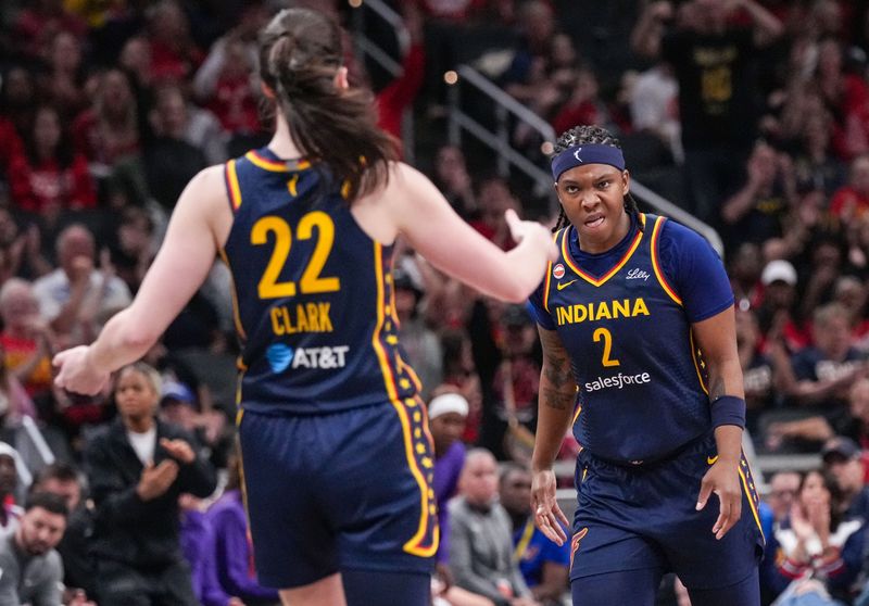 Indiana Fever forward Myisha Hines-Allen (2) celebrates with Indiana Fever guard Caitlin Clark (22) after an assist from to lead to a three-point basket Monday, June 22, 2026, during the game at Gainbridge Fieldhouse in Indianapolis.