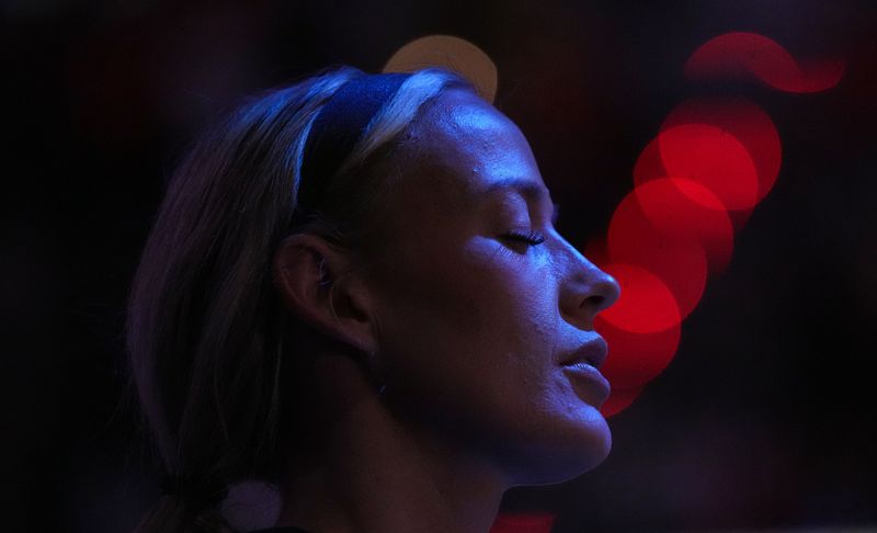 Indiana Fever guard Sophie Cunningham (8) closes her eyes during the national anthem on Monday, June 22, 2026, during the game at Gainbridge Fieldhouse in Indianapolis.