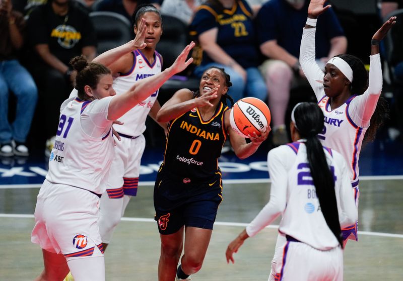 Indiana Fever guard Kelsey Mitchell (0) attempts to push through Phoenix Mercury players during the Indiana Fever vs. Phoenix Mercury game Monday, June 22, 2026, at Gainbridge Fieldhouse in Indianapolis.