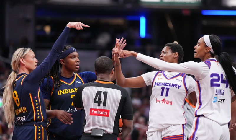 Indiana Fever guard Sophie Cunningham (8) points at Phoenix Mercury forward-guard DeWanna Bonner (24) as an argument broke out between the two players on Monday, June 22, 2026, during the game at Gainbridge Fieldhouse in Indianapolis. The Indiana Fever defeated the Phoenix Mercury, 86-77.