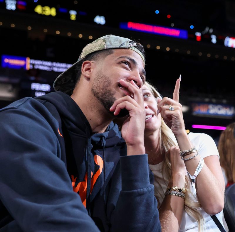 Indiana Pacers guard Tyrese Haliburton and fiancé Jade Jones look at the screen Wednesday, June 24, 2026, during the first half of a game at Gainbridge Fieldhouse in Indianapolis.