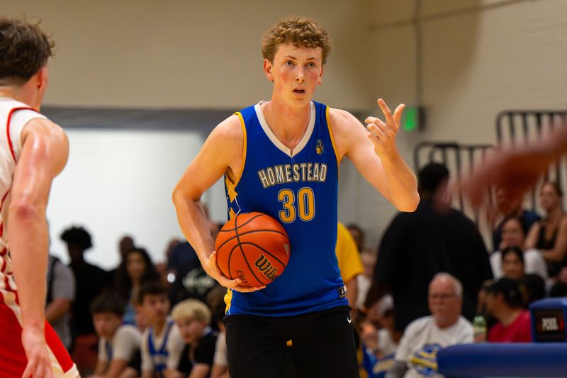 Homestead High School’s Mack Welker, right, gestures. Players compete during the 2026 IBCA/IHSAA Boys Team Showcase in Memory of Charlie Hughes at Carmel High School in Carmel, Ind., Saturday, June 27, 2026. The annual event brings together many of Indiana’s top high school boys basketball teams for a series of offseason showcase games while honoring the legacy of longtime basketball coach and educator Charlie Hughes, whose contributions to the sport helped shape generations of players and coaches throughout the state.