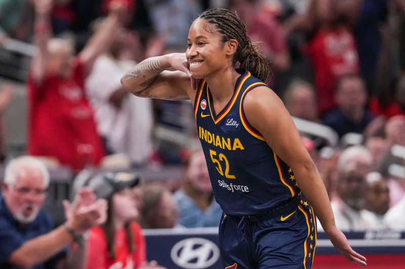 Indiana Fever guard Tyasha Harris (52) celebrates a 3-pointer Saturday, June 27, 2026, during the first half of a game at Gainbridge Fieldhouse in Indianapolis.