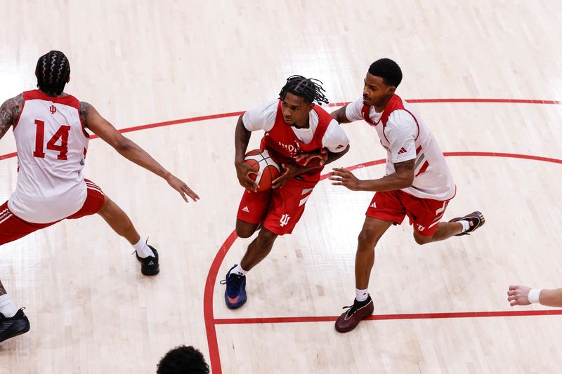 IU guard Markus Burton splits two defenders during practice Tuesday morning at Cook Hall, in Bloomington, Ind. Burton and the Hoosiers will play an exhibition game next Wednesday in Bloomington, before traveling to Peru for the FISU America Games.