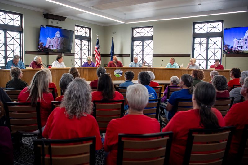 People fill the room in red shirts showing support to protect Posey County from data centers as the Posey County Area Plan Commission meets to discuss updating zoning rules in Mount Vernon, Ind., Thursday, July 9, 2026.