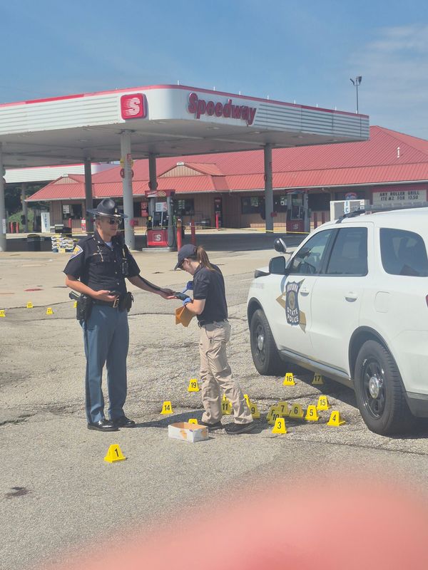 Police working the scene where a trooper was shot multiple times.  Each yellow marker was placed where empty shell casings were found.