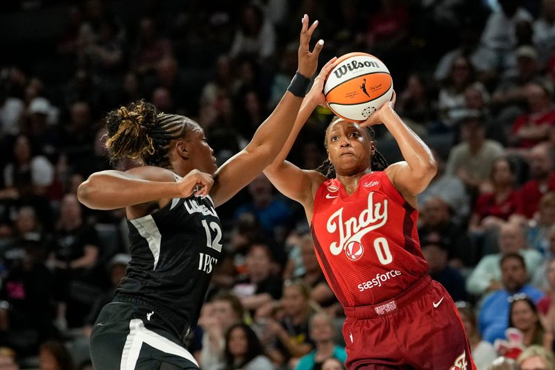 Jul 12, 2026; Las Vegas, Nevada, USA; Indiana Fever guard Kelsey Mitchell (0) shoots the ball against Las Vegas Aces guard Chelsea Gray (12) during the first quarter of a WNBA basketball game at Michelob Ultra Arena.