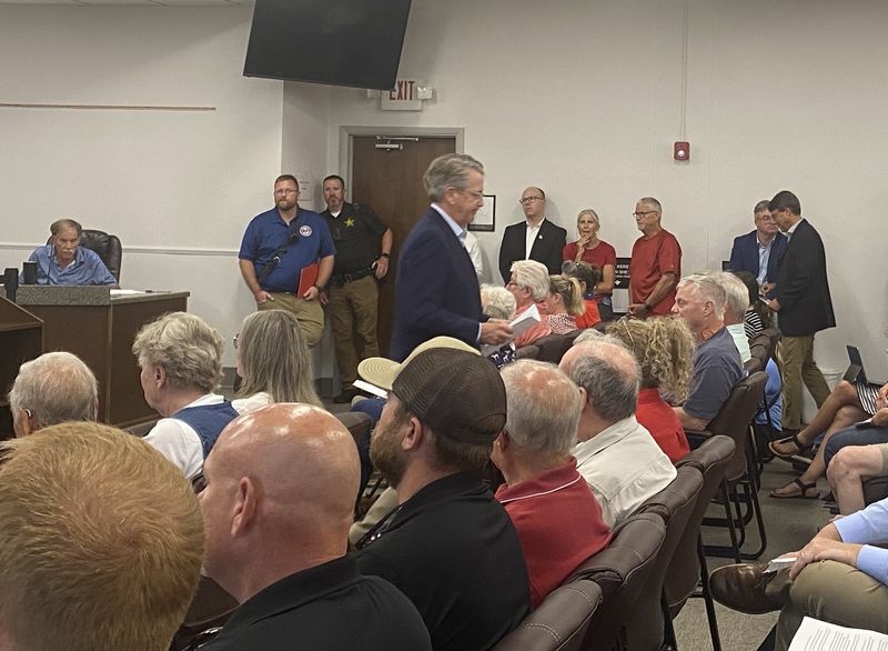 Lloyd Winnecke, president and CEO of the Evansville Regional Economic Partnership, heads back to his seat after asking the Warrick County Area Plan Commission to table its ordinance on data centers July 13, 2026, in Boonville, Indiana.