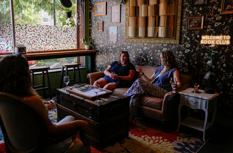 Shelby Gruner from Greenwood (left) talks with Jennifer Black on Tuesday, July 14, 2026, at Moonlit Vine Bookstore & Wine Bar in Beech Grove.