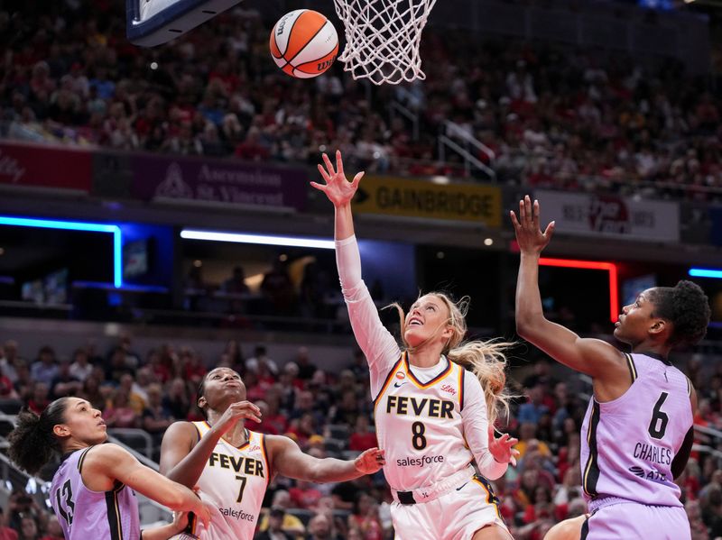 Indiana Fever guard Sophie Cunningham (8) goes up for a basket against Golden State Valkyries guard Kaila Charles (6) on Wednesday, July 15, 2026, during the second half of a game at Gainbridge Fieldhouse in Indianapolis. The Golden State Valkyries defeated the Indiana Fever, 88-75.