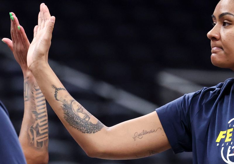 Indiana Fever guard Tyasha Harris (52) high-fives Indiana Fever center Damiris Dantas (12) on Friday, July 17, 2026, before a game at Gainbridge Fieldhouse in Indianapolis.