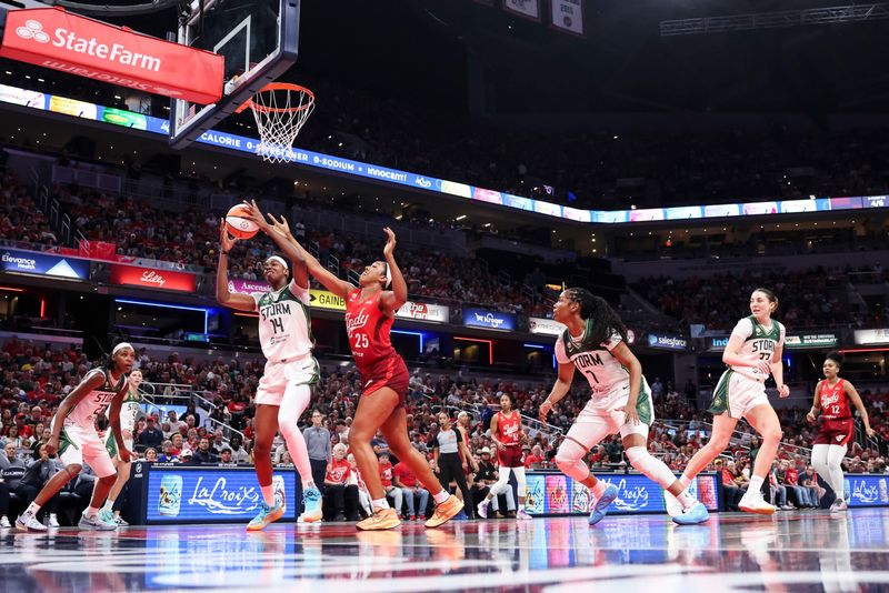 Seattle Storm center Dominique Malonga (14) and Indiana Fever forward Monique Billings (25) go for the ball Friday, July 17, 2026, during the first half of a game at Gainbridge Fieldhouse in Indianapolis.