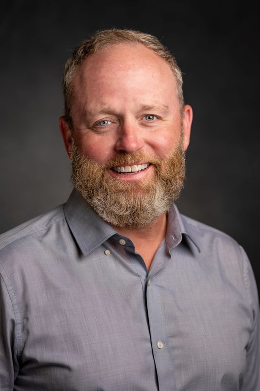 Elkhart High School Athletic Director Josh Fletcher smiles for a headshot.