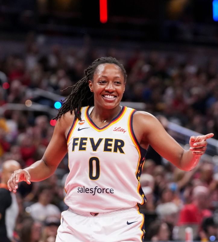 Indiana Fever guard Kelsey Mitchell (0) smiles after scoring Wednesday, July 22, 2026, during a game at Gainbridge Fieldhouse in Indianapolis.