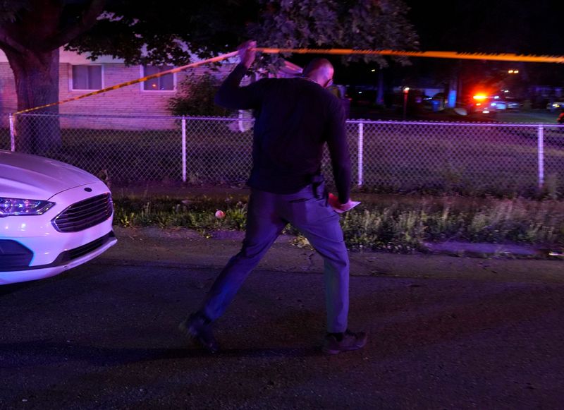 Members of law enforcement work the scene of a shooting Wednesday, July 22, 2026, on the 8000 block of East 37th Street in Indianapolis. Officers were sent to a disturbance around 10:30 p.m.. A man at the scene shot and struck two IMPD officers. At least one officer returned fire, leaving the man in critical condition.