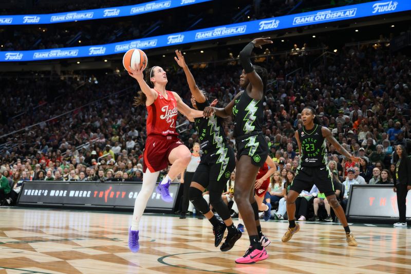 Jul 28, 2026; Seattle, Washington, USA; Indiana Fever guard Caitlin Clark (22) shoots the ball while guarded by Seattle Storm center Awa Fam (11) during the the second half at Climate Pledge Arena. Mandatory Credit: Steven Bisig-Imagn Images
