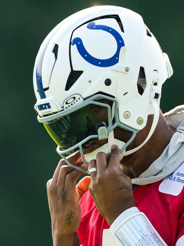 Indianapolis Colts quarterback Anthony Richardson Sr. (5) puts on his helmet Wednesday, July 29, 2026, during the Colts Camp Kickoff at Grand Park in Westfield.