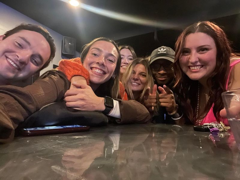 Darian Wiley and Olivia Brown (center) smile with a group of their friends. Brown and Wiley were shot and killed in Indianapolis on May 6, 2023. Lauren Prestamer, Brown's sister, said it wasn't a surprise the two friends were together that night.