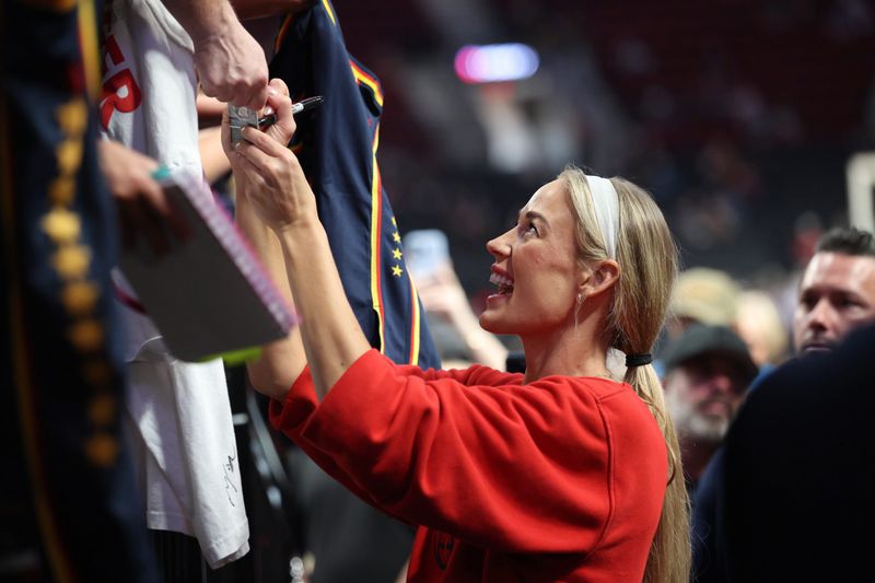 Jul 31, 2026; Portland, Oregon, USA;  Indiana Fever guard Sophie Cunningham (8) signs autographs for fans before a game against the Portland Fire at Moda Center. Mandatory Credit: Jaime Valdez-Imagn Images