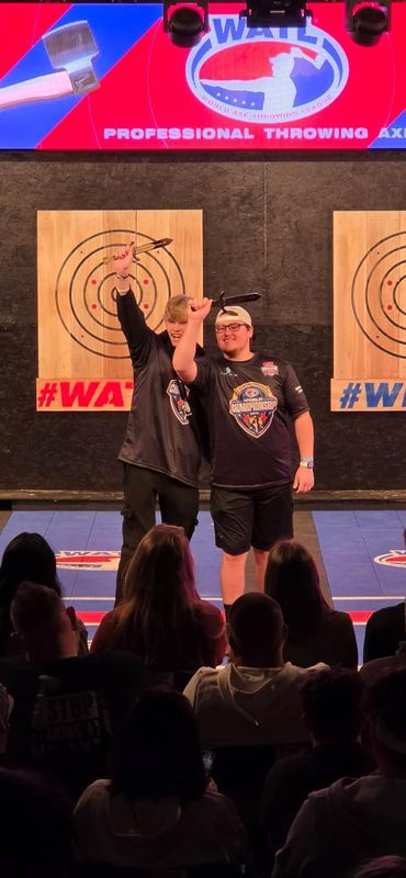 Michigan residents Colbe Pudell and Louie Perkins are shown after claiming a World championship in knife duals throwing competition this Spring in Tulsa, Oklahoma.